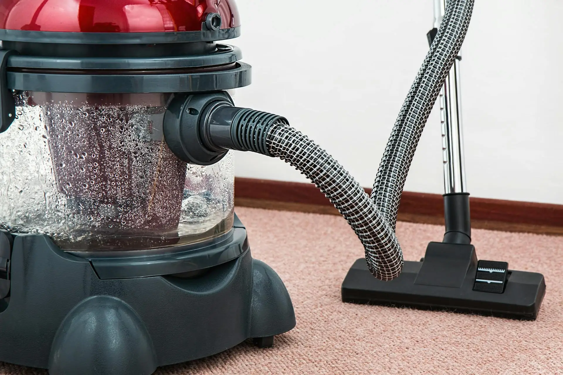 Red and black vacuum to clean up water damage at home