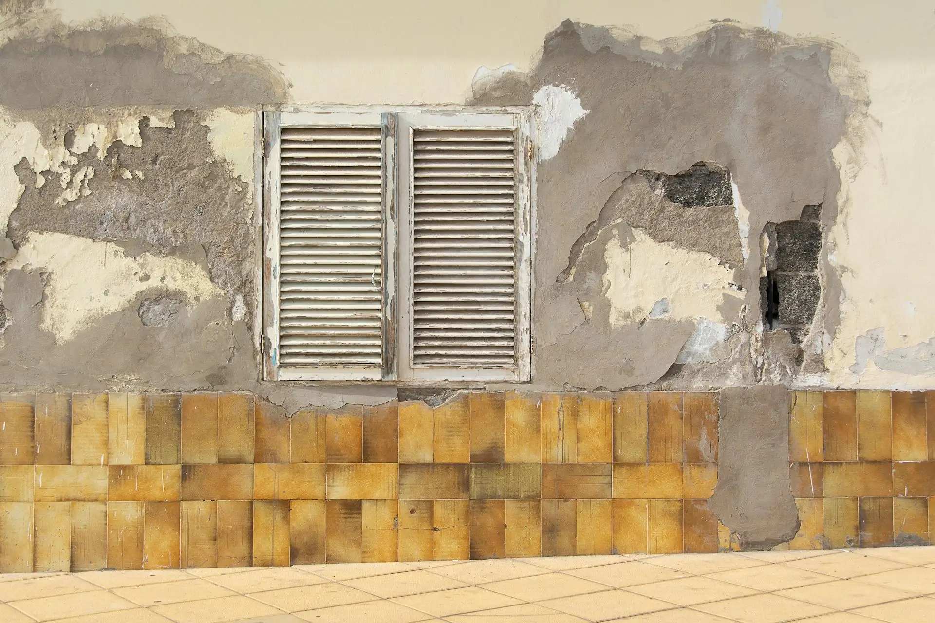 Aged Wall with Water Damage and Peeling Paint