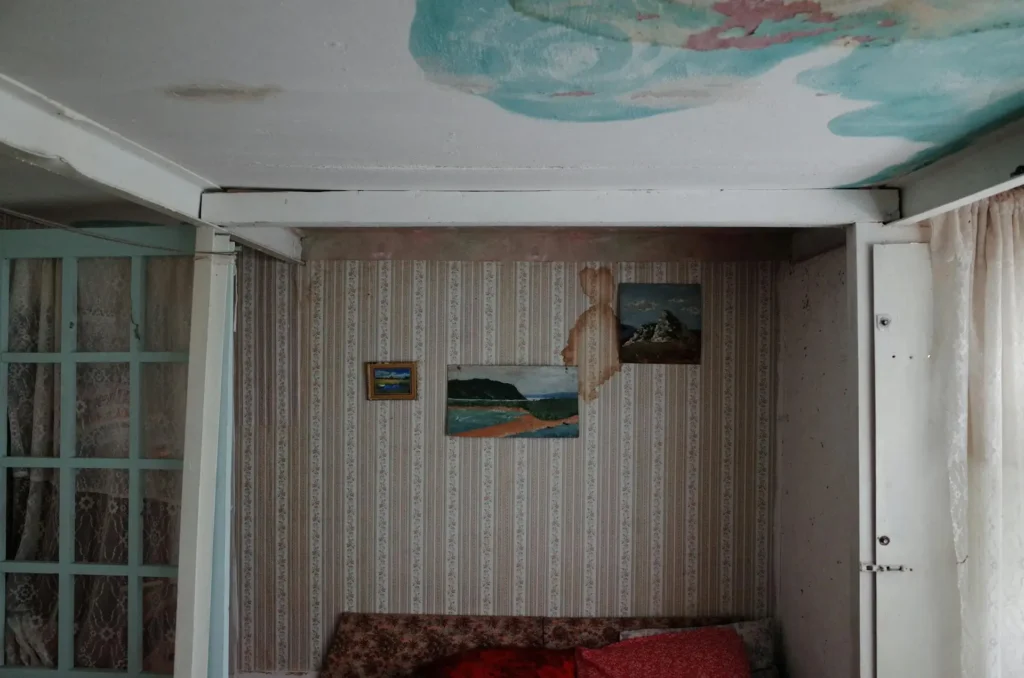 Room with water-damaged walls and ceiling